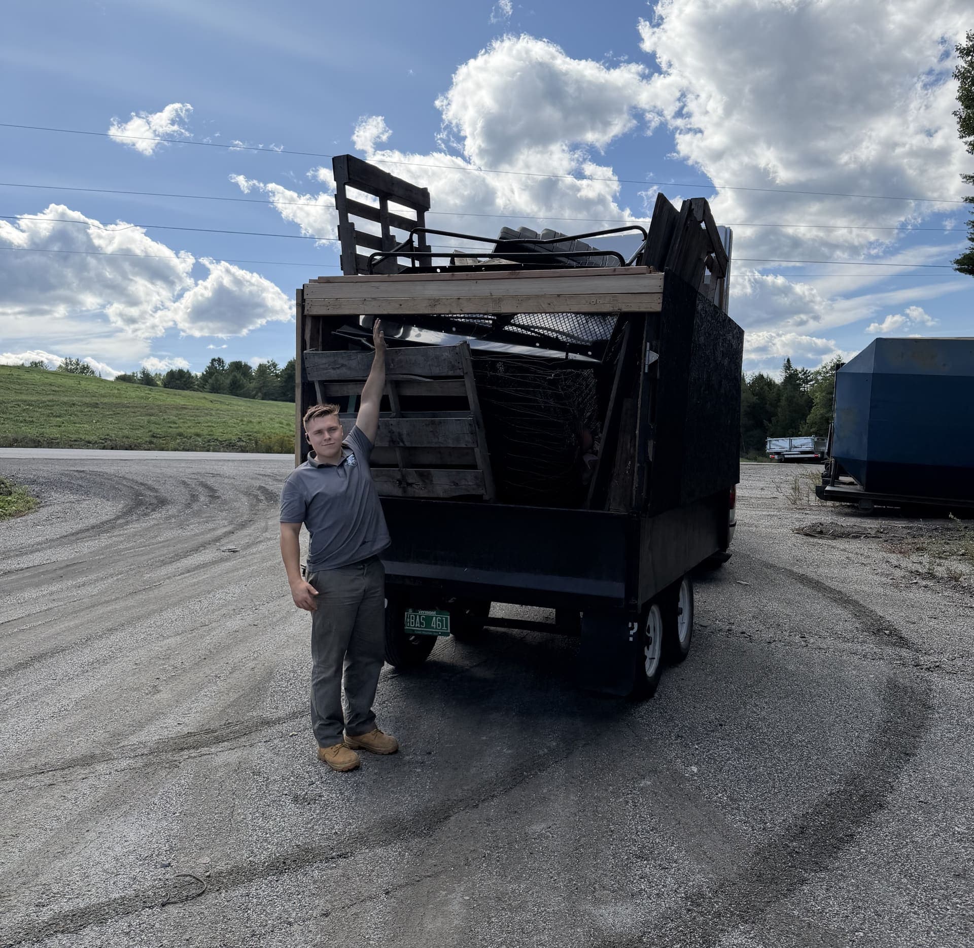 Zack Lacey next to a fully loaded 10x6x5 junk removal trailer in Vermont